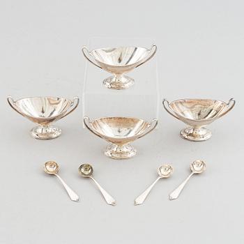 Four silver salt cellars with spoons, Edward Barnard & Sons Ltd, London, England, 1880.