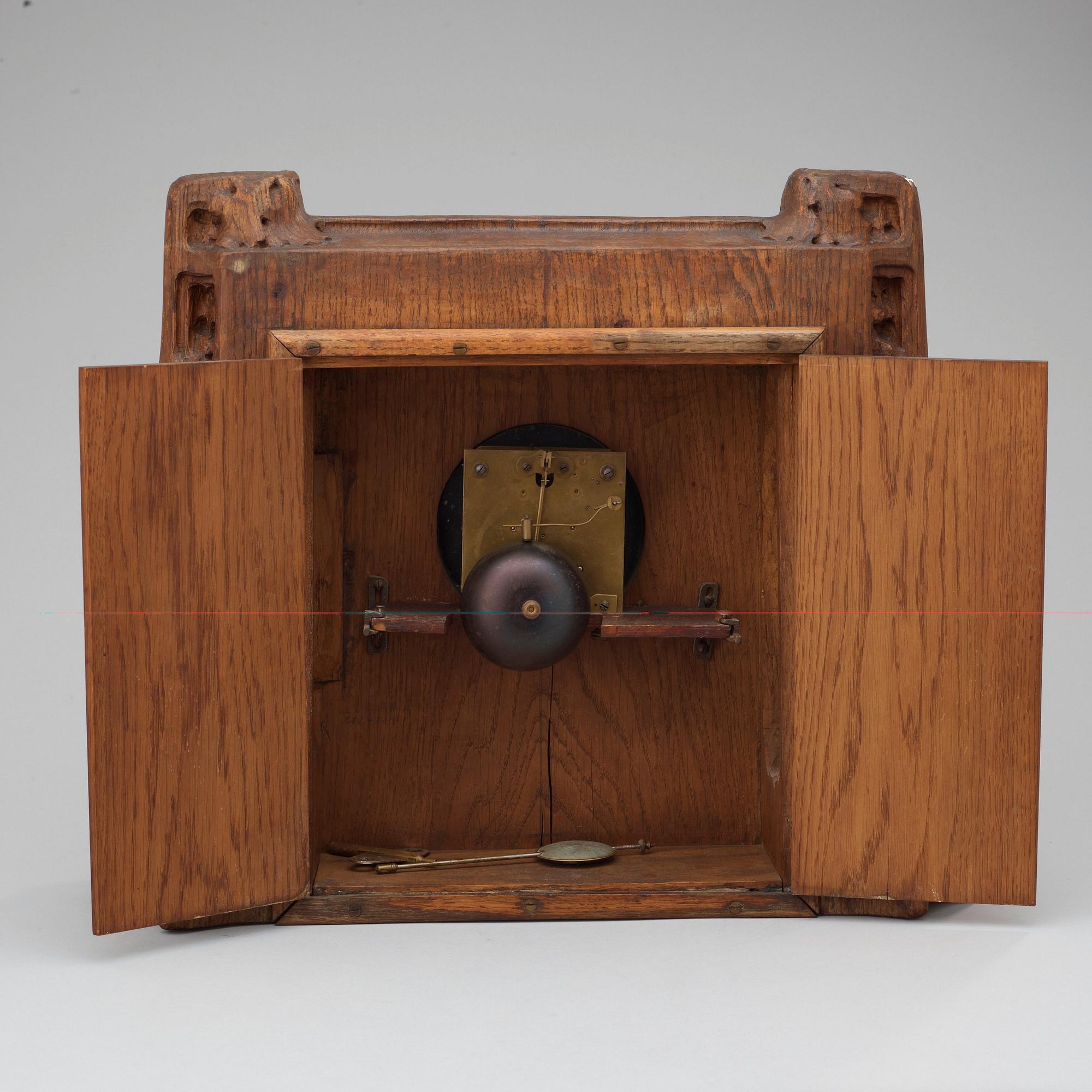 A Swedish Art Nouveau carved pine mantel clock, probably by Rackengruppen.