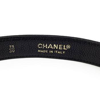 A black leather belt by Chanel.