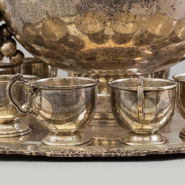 A first half of the 20th century silver punch bowl with twelve cups.