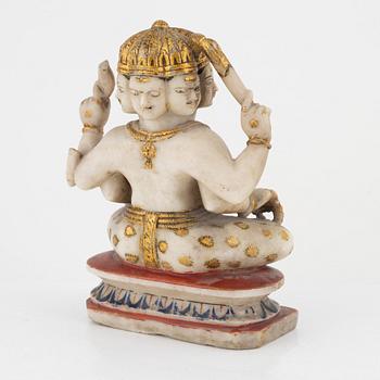 An alabaster sculpture of an deity with six heads and four arms, India, 19th Century.