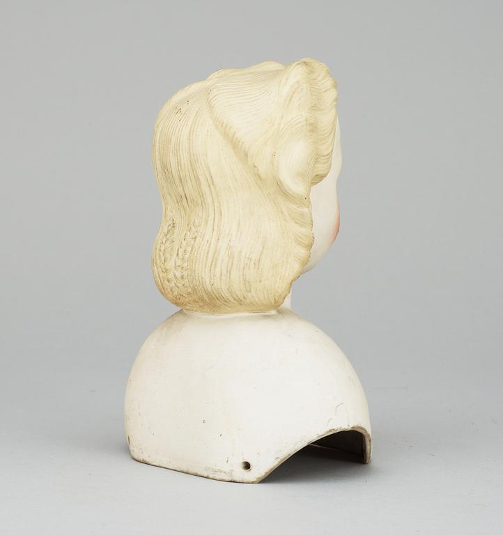 A 1860s-70s doll head, probably Germany.