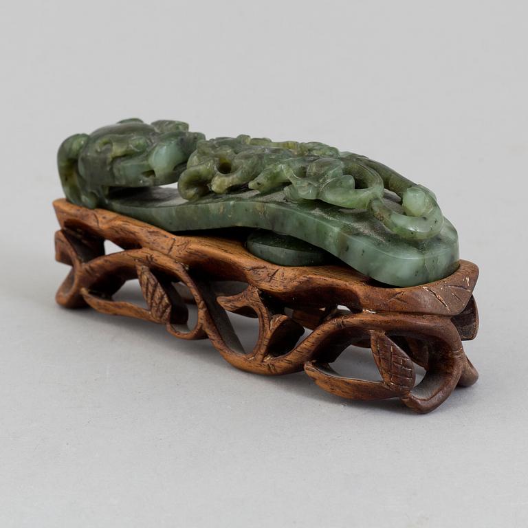 A green stone belt hook, China, early 20th Century.