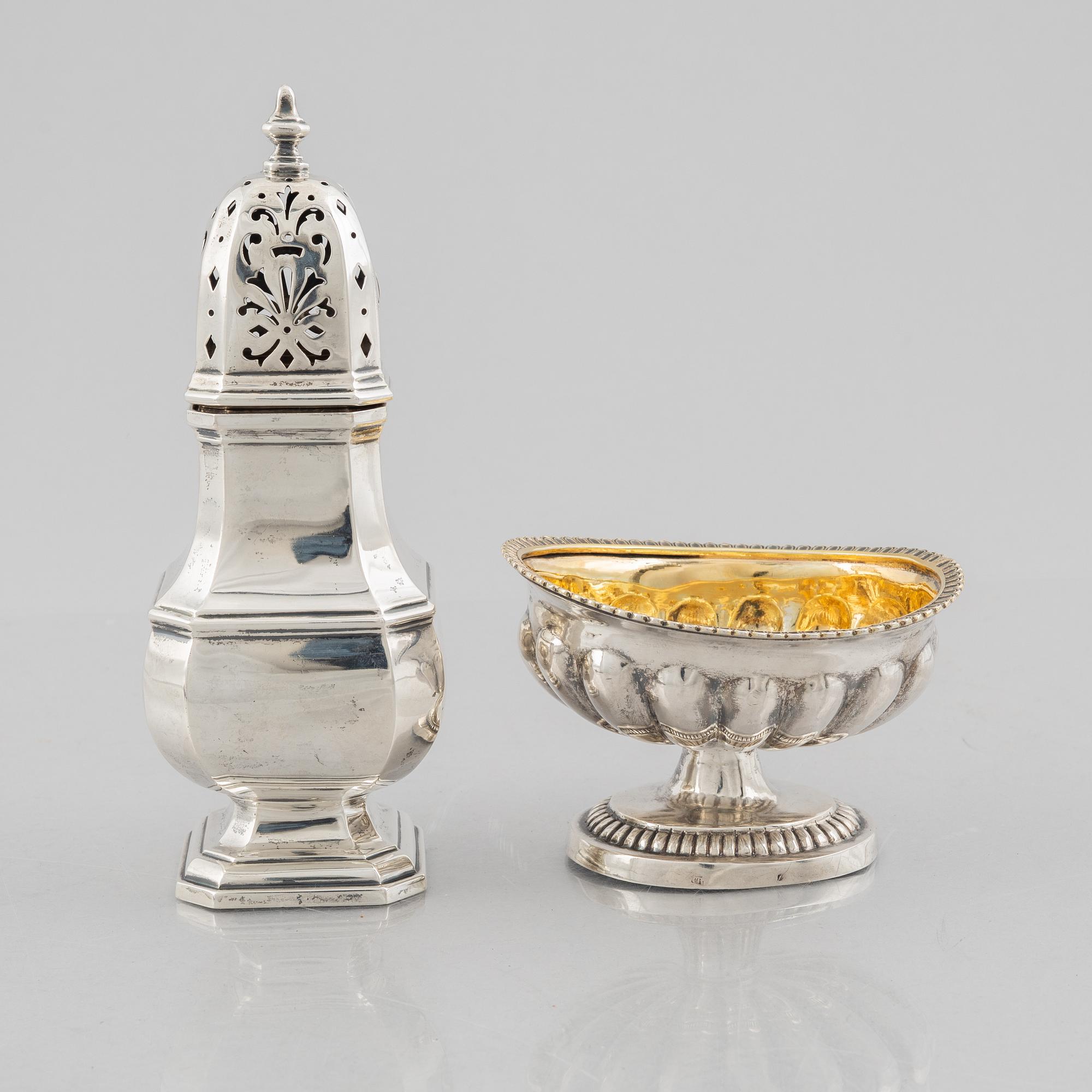A silver sugar caster from E. S. Barnsley & Co, Birmingham,  1914, and a silver salt cellar with indistinct marks.