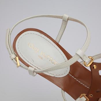 LOUIS VUITTON, a pair of white wedge heel sandalettes.