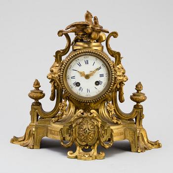A table CLOCK and a pair of candelabra, second part of 19th century.
