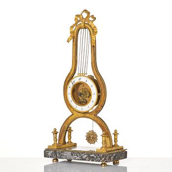 A French Louis XVI ormolu and marble lyre-shaped mantel clock, late 18th century.