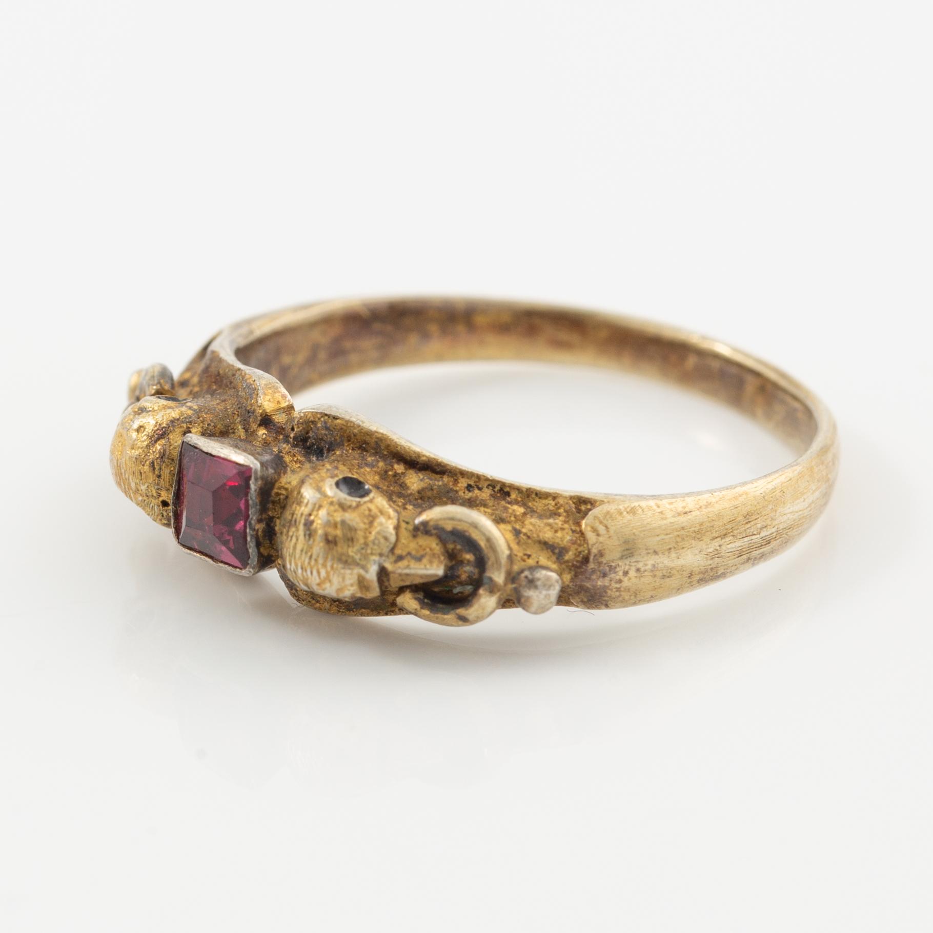 Two rings in silver with pink/red stones.
