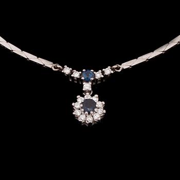 HÄNGSMYCKE, 14K vitguld, 2 safirer, diamanter tot. 0,30 ct. Vikt 10,9 g.