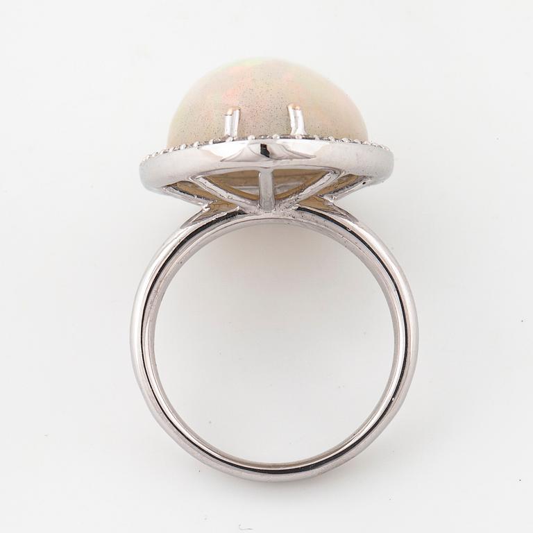 A cabochon cut white opal and a brilliant cut diamond ring.