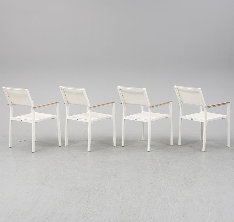 A garden table with four chairs, Gloster.