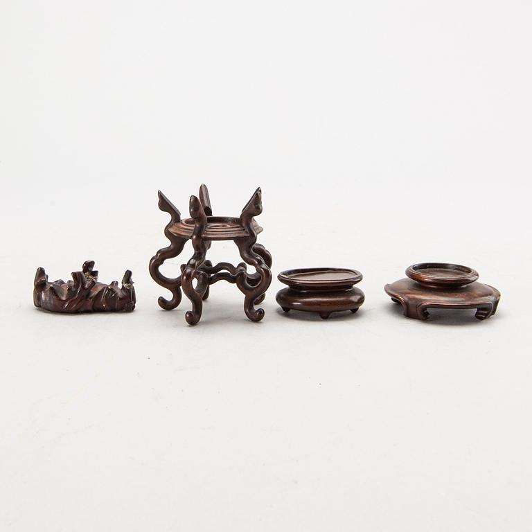 A set of four bronze giurines, a wooden bowl, two stands and one porcelain cup with stand, 20th century.