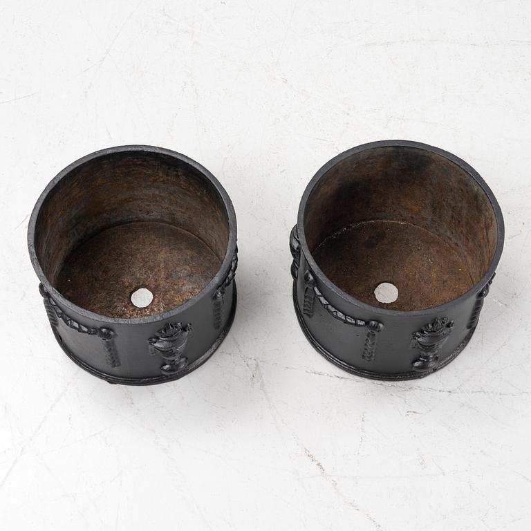 A pair of cast-iron planters, later part of the 20th century.