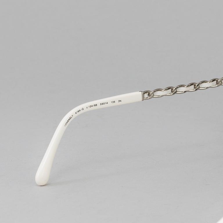 A pair of sunglasses by Chanel.