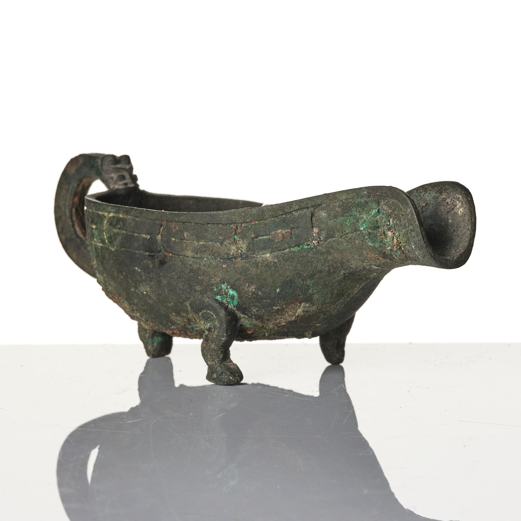 A Chinese brushpot, Qing dynasty, circa 1900. An archaistic bronze ewer and a silvered South East Asian bowl with stand.