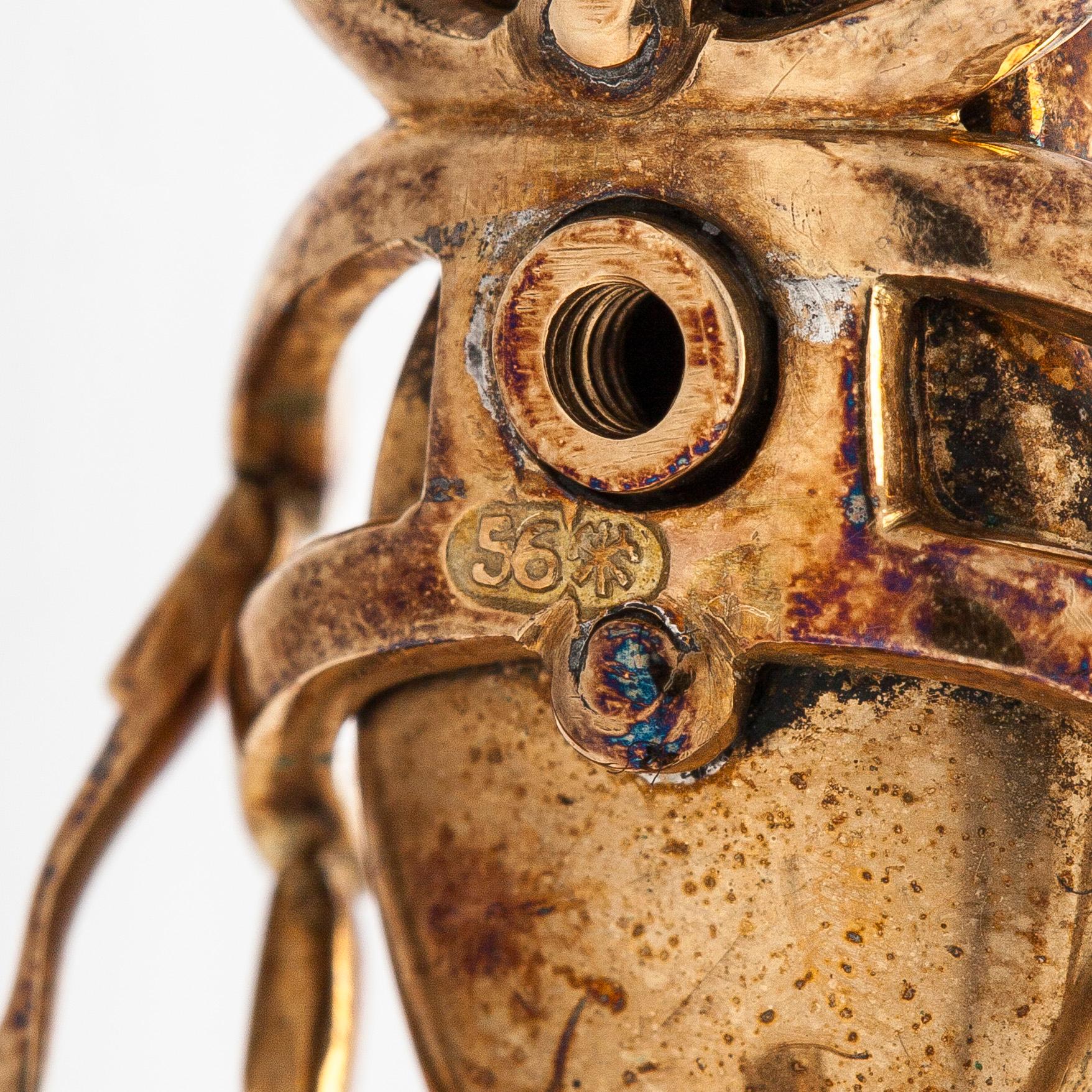 A 14K gold brooch with tiger’s eye, old-cut and rose-cut diamonds, ruby, emeralds. St. Petersburg.