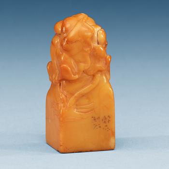 1470. A yellow soapstone seal.