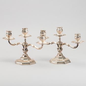 A pair of silver candelabras.