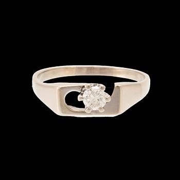 An 18K white gold solitaire ring set with a round brilliant-cut diamond.