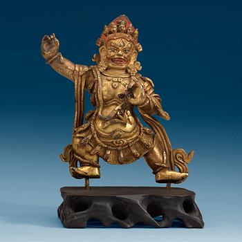 1385. A Sinotibetan gilt bronze  figure of a Dharmapala.