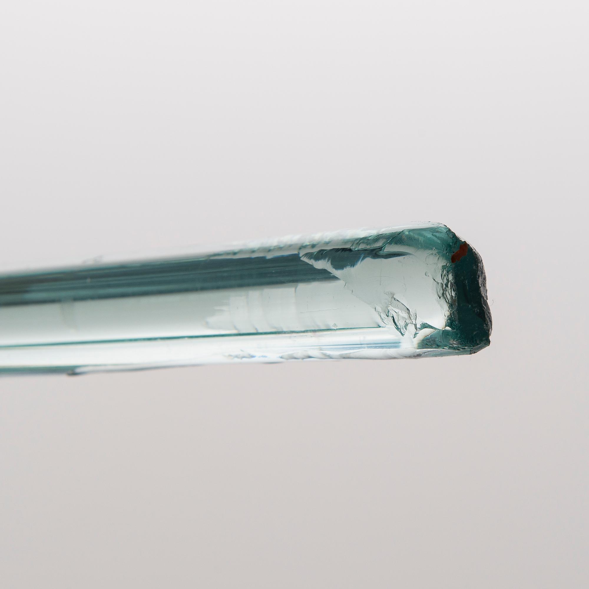 A greenish glass walking stick.
