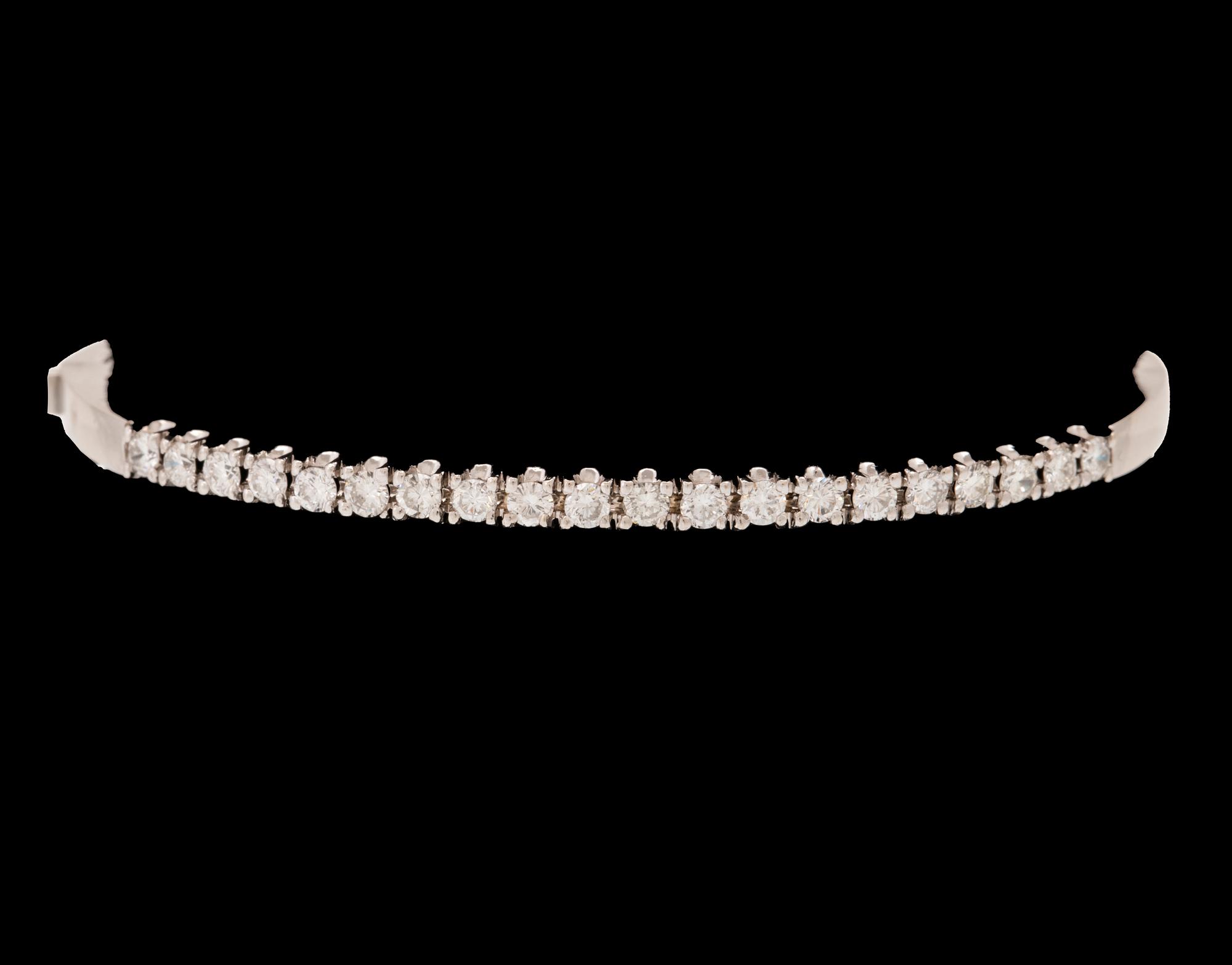 An 18K white gold bracelet set with round brilliant-cut diamonds.