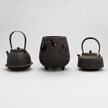 Two teapots and a hibachi brazier, Japan, early/ first half of the 20th century.