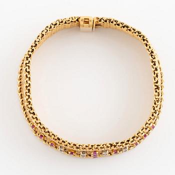 An 18K gold bracelet set with round brilliant-cut diamonds and rubies.