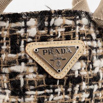 Prada, a tweed and leather bag.