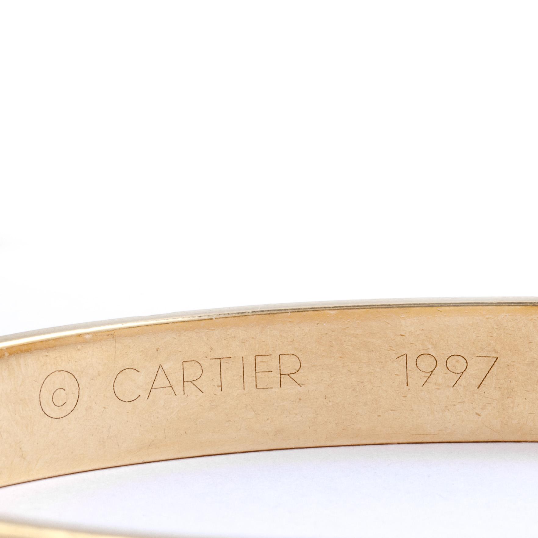 ARMRING, 18k guld besatt med diamant, ca 0,05 ct. Cartier. Vikt ca 39 g.