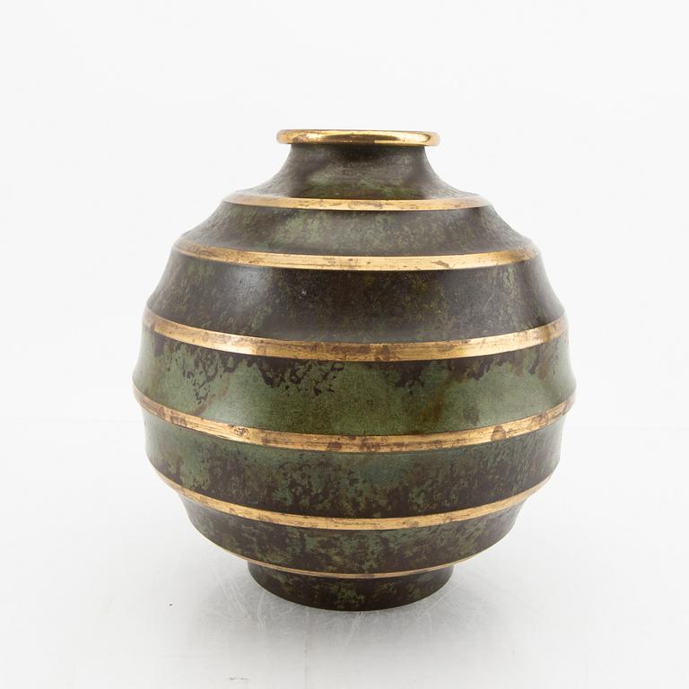 A 1930s metal vase.