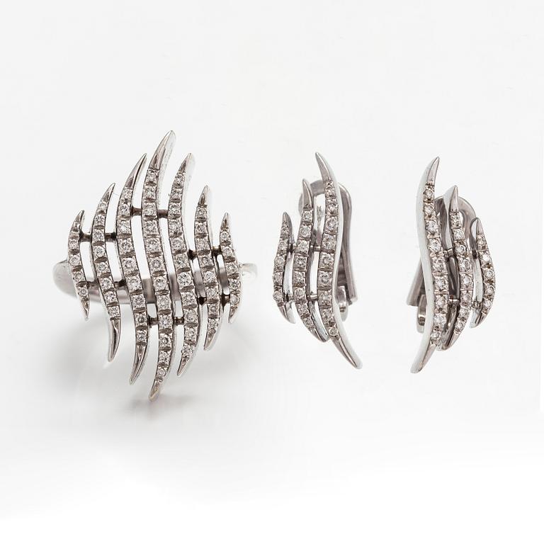 A pair of 18K white gold earrings and a ring with diamonds ca. 0.90 ct in total. Moscow.