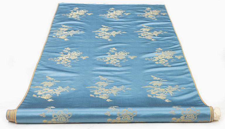 A bolt of Chinese pale blue and gold silk fabric, early 20th century.