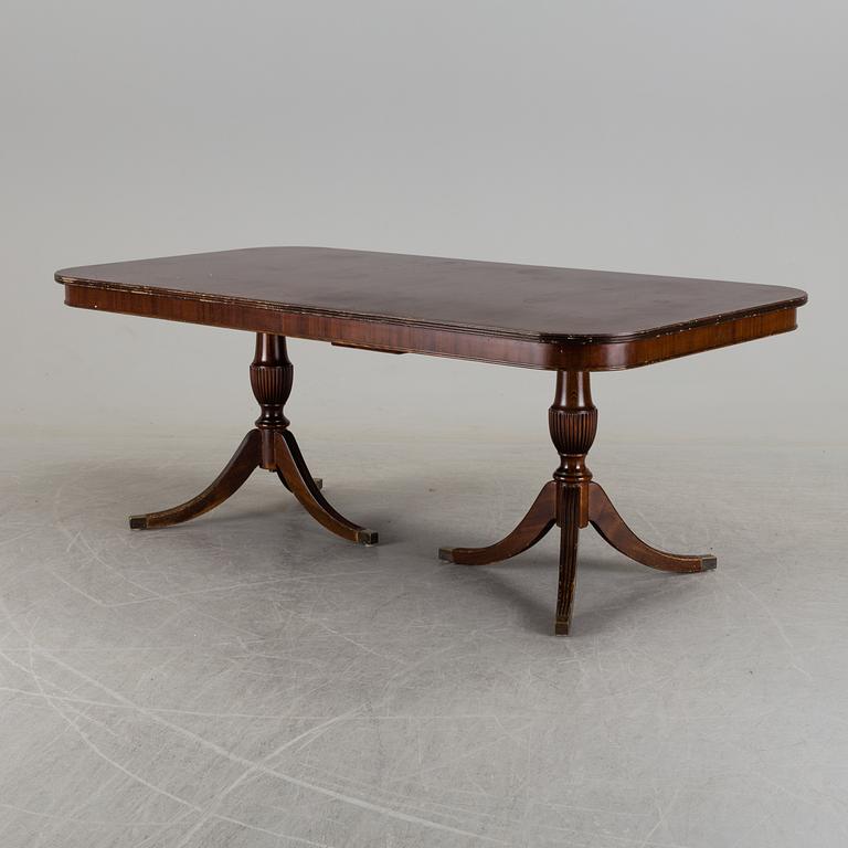 A second half of the 20th century mahogany  dining table with 5 additional leaves.