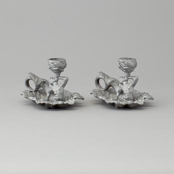 A pair of cast iron candlesticks, marked Verlag bei, A. Meves, Berlin, late 20th century.