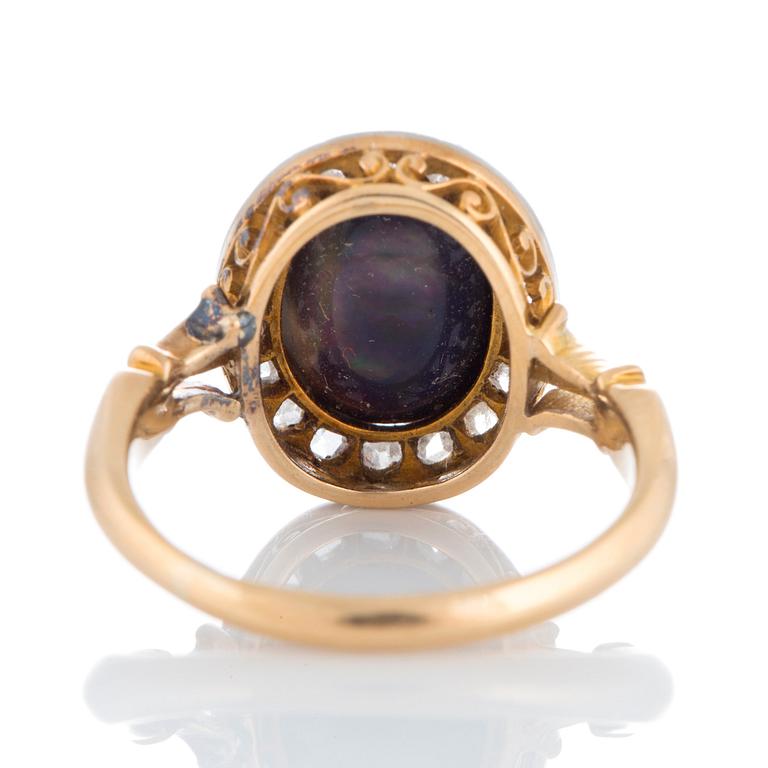 An opal ring set with rose-cut diamonds.