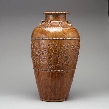 A large brown glazed Martaban jar, presumably 18th Century.