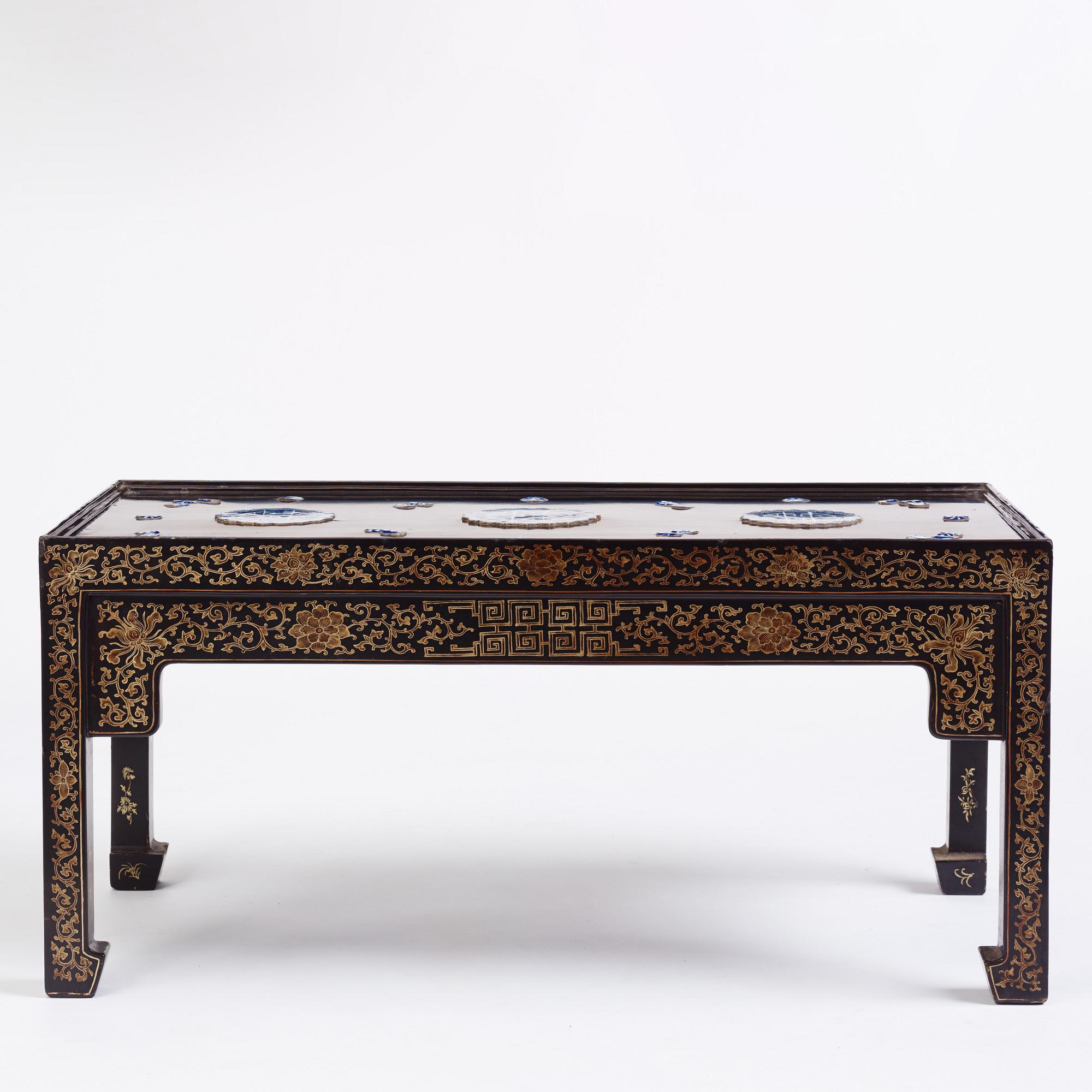 A Chinese black lacquered table with porcelain placques, presumably first half of the 20th century.