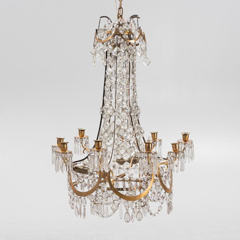 A Louis XVI gilt-brass and cut glass nine-light chandelier, circa 1800.