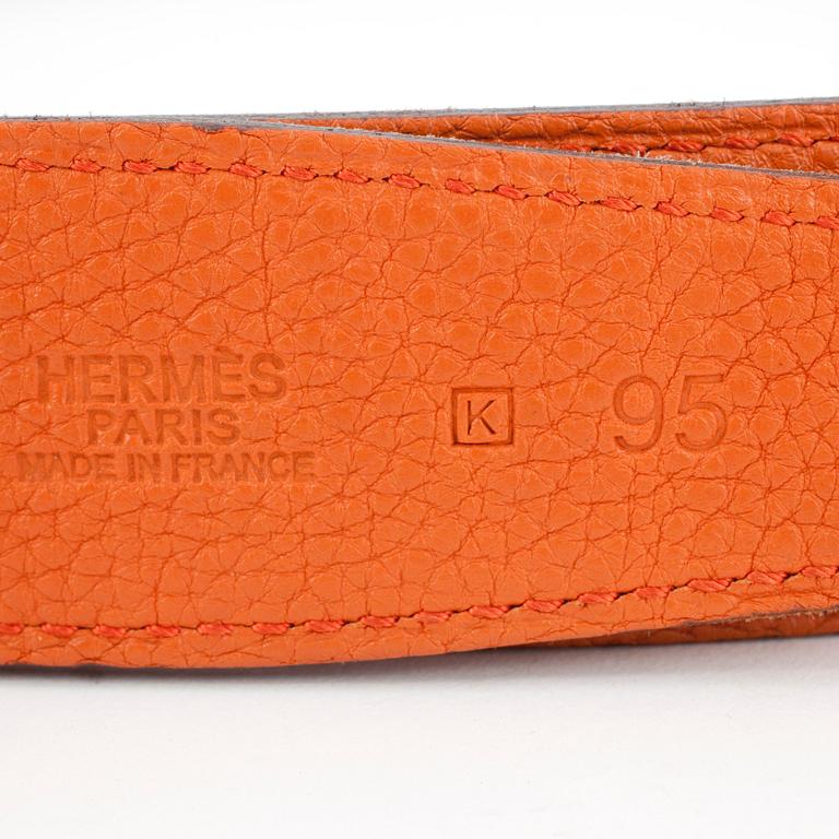 HERMÈS, a men's orange and brown leather reversibel belt.