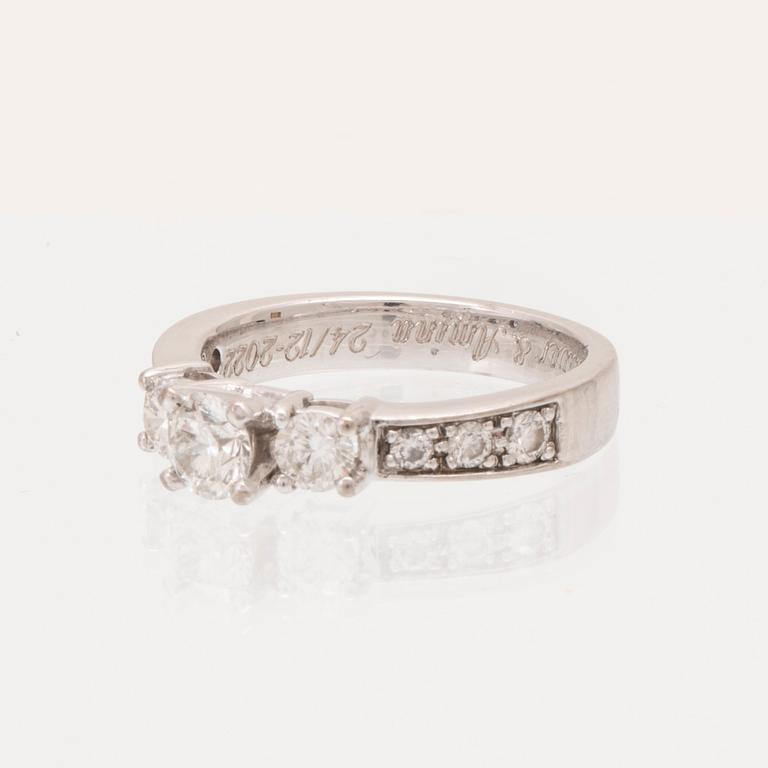 An 18K white gold ring set with round brilliant cut diamonds.