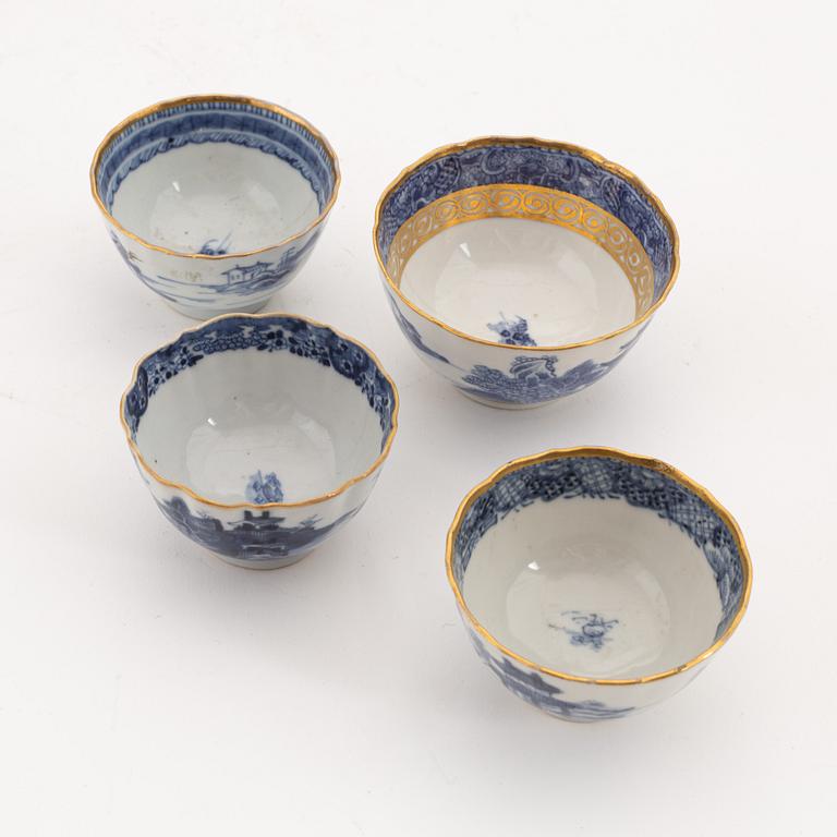 A set of seven gilt and blue and white cups, two saucers, a plate and a dish, Qing dynasty, 18th and 19th century.