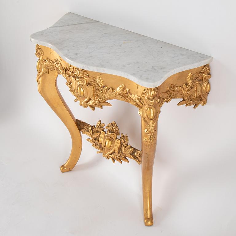 A mirror and console table from around the year 1900.