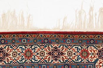 A carpet, semi-antique, Qum, ca 324 x 221 cm.