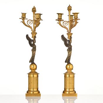 A pair of Empire ormolu three-light candelabra, early 19th century.