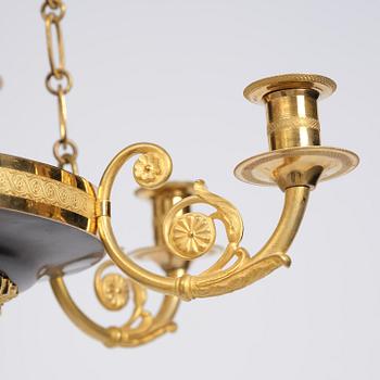 A Swedish Empire ormolu and patinated six-branch chandelier, Stockholm, early 19th century.
