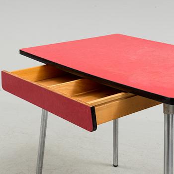 A mid 20th century table and chair.
