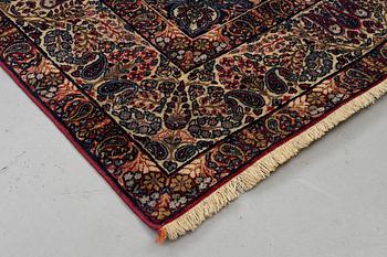 A carpet, semi-antique Kerman Laver, ca 242 x 142 cm.