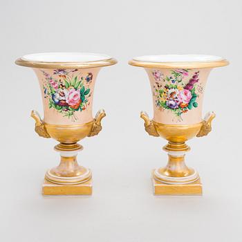 A pair of German porcelain urns from around the mid-19th century.
