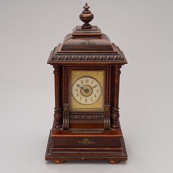 An early 20th century German Junghans table clock with music box.